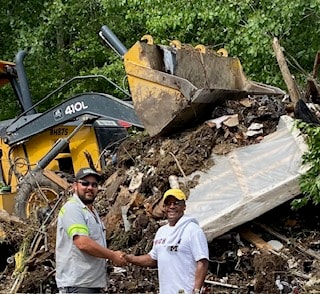 Two workers shaking hands at construction site