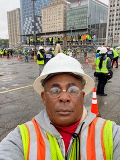 Terrence M. Hicks in hard hat and safety vest at active construction site in Detroit