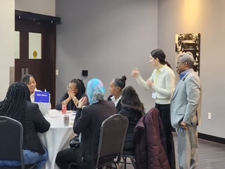 Small group discussion at indoor community event